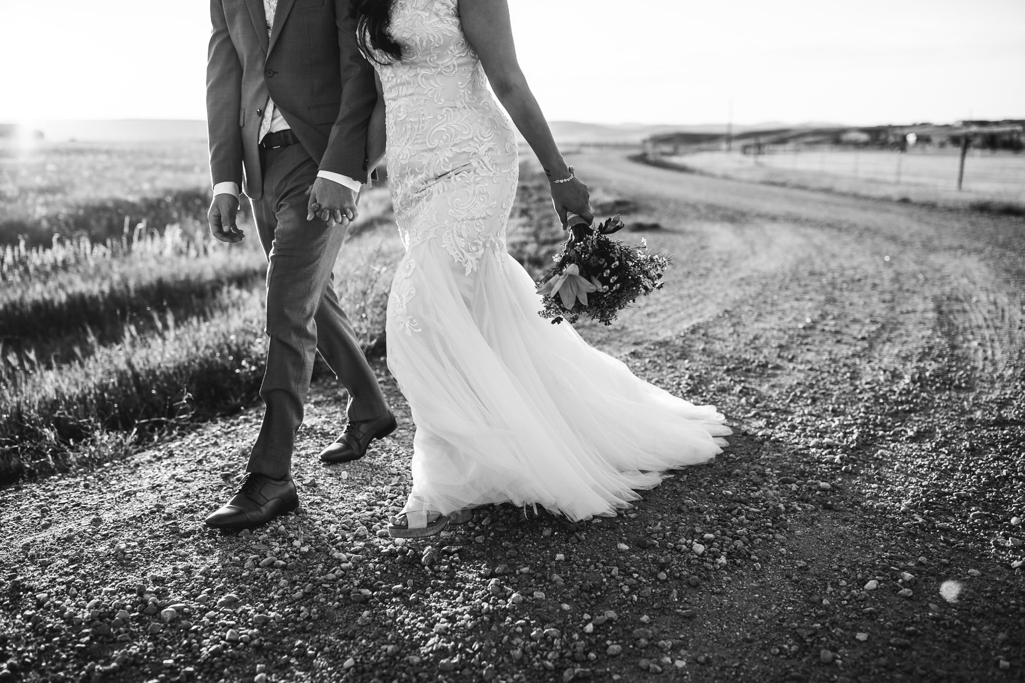 Bride groom walking on dirt road