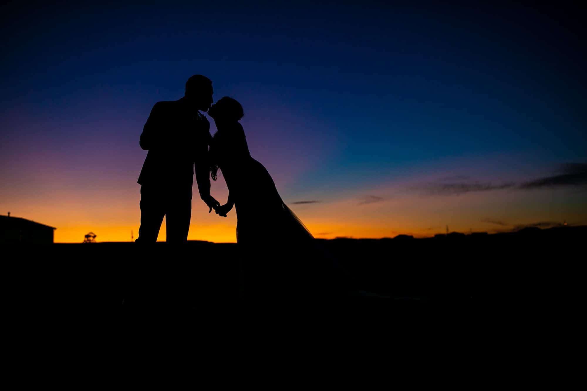 bride and groom kissing sunset wyoming