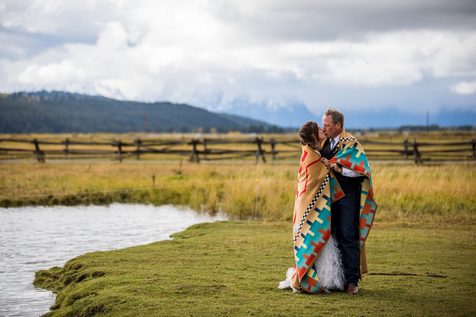 bride groom kissing with navajo blanket