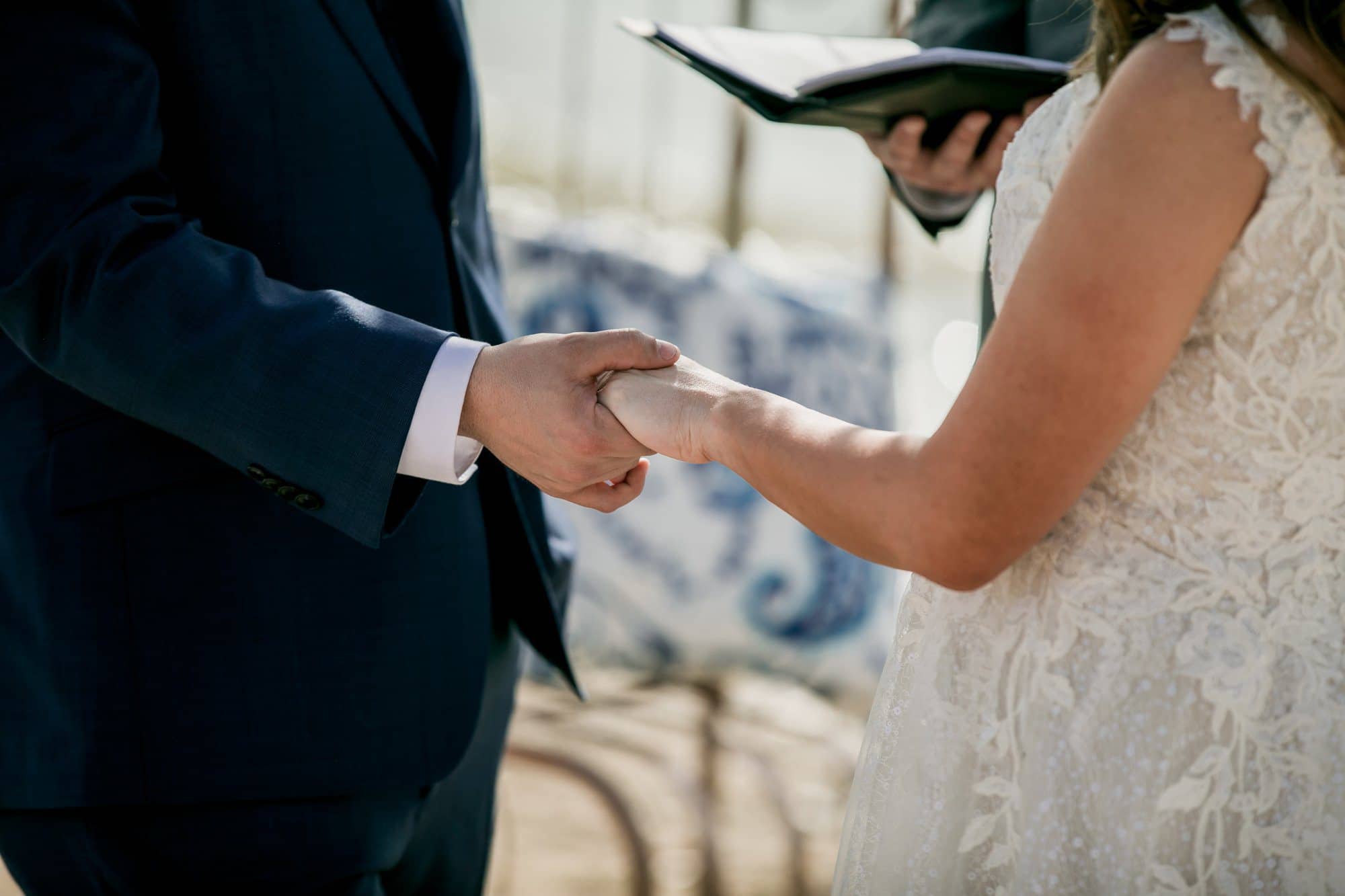 bride and groom hands during ceremony