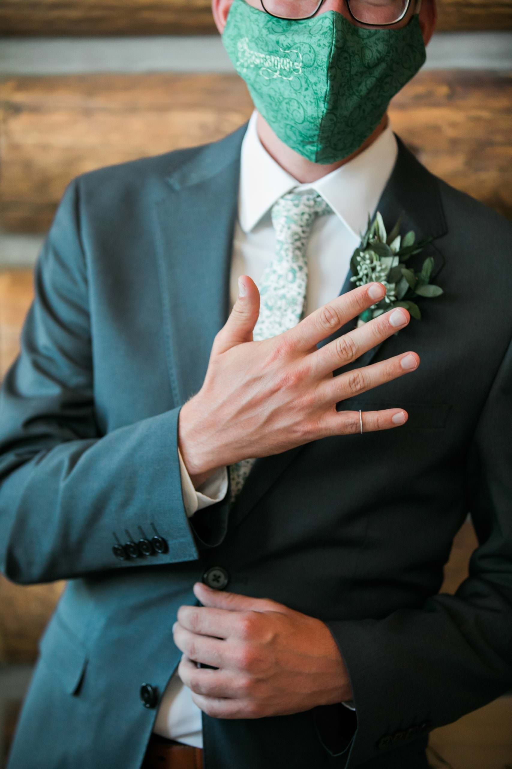 best man holding bride's ring