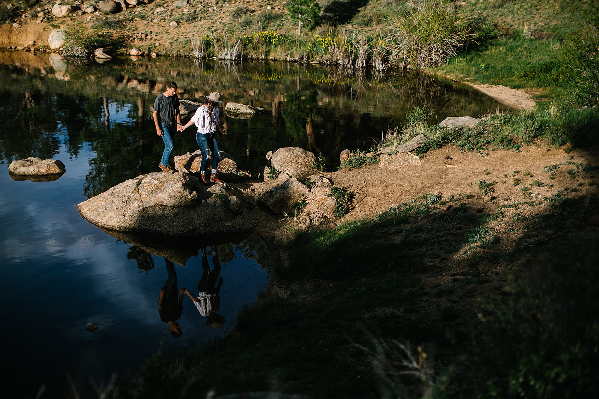 couple walking by water for engagement session