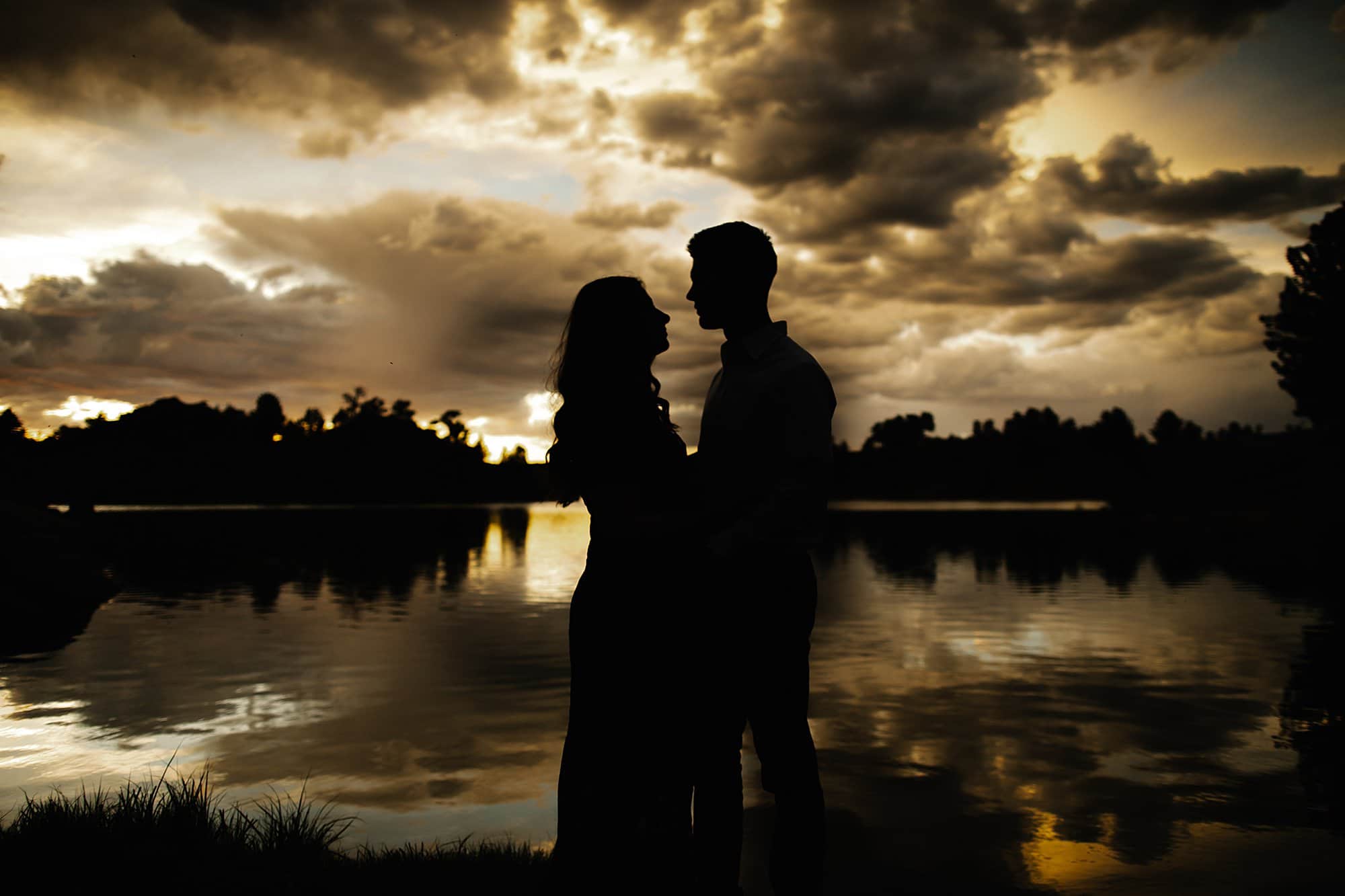 sunset photo over water of couple
