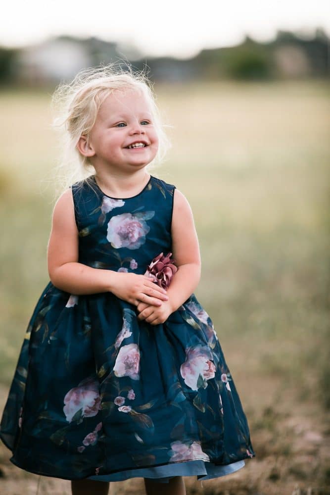 little girl in field smiling