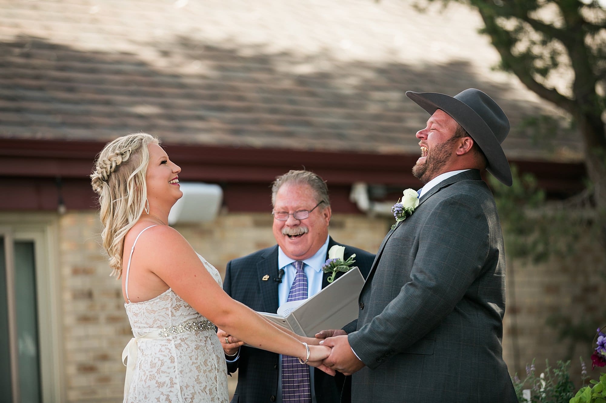 bride and groom laughing during ceremony