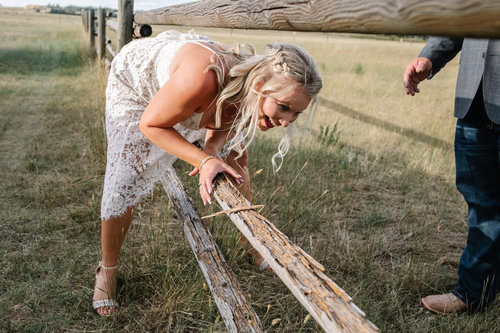 bride climbing through fence