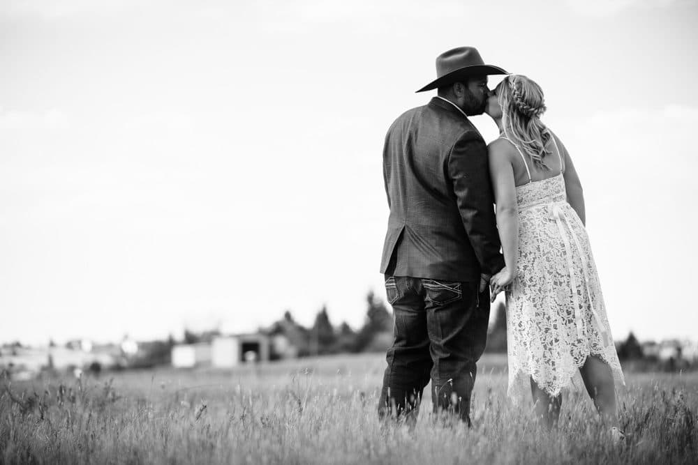cowboy bride and groom in cheyenne wyoming field