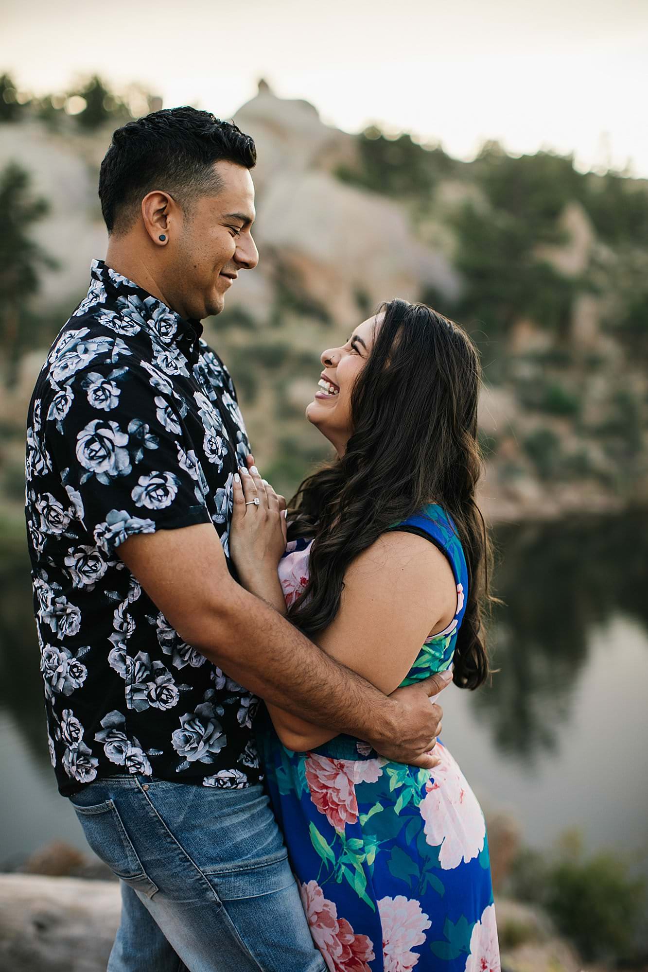 couple laughing on trail for engagement session, wyoming