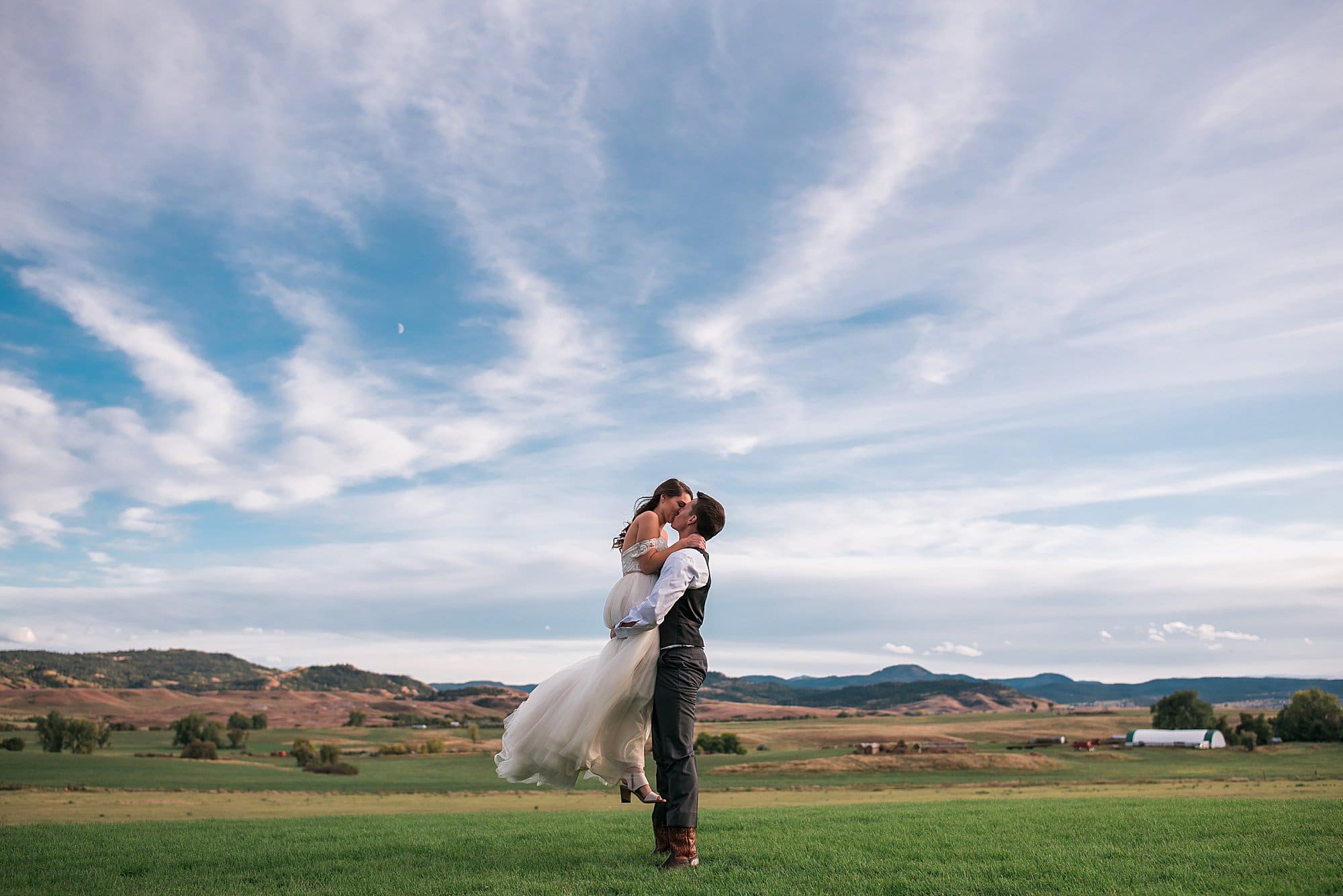 bride and groom with sky at sunset